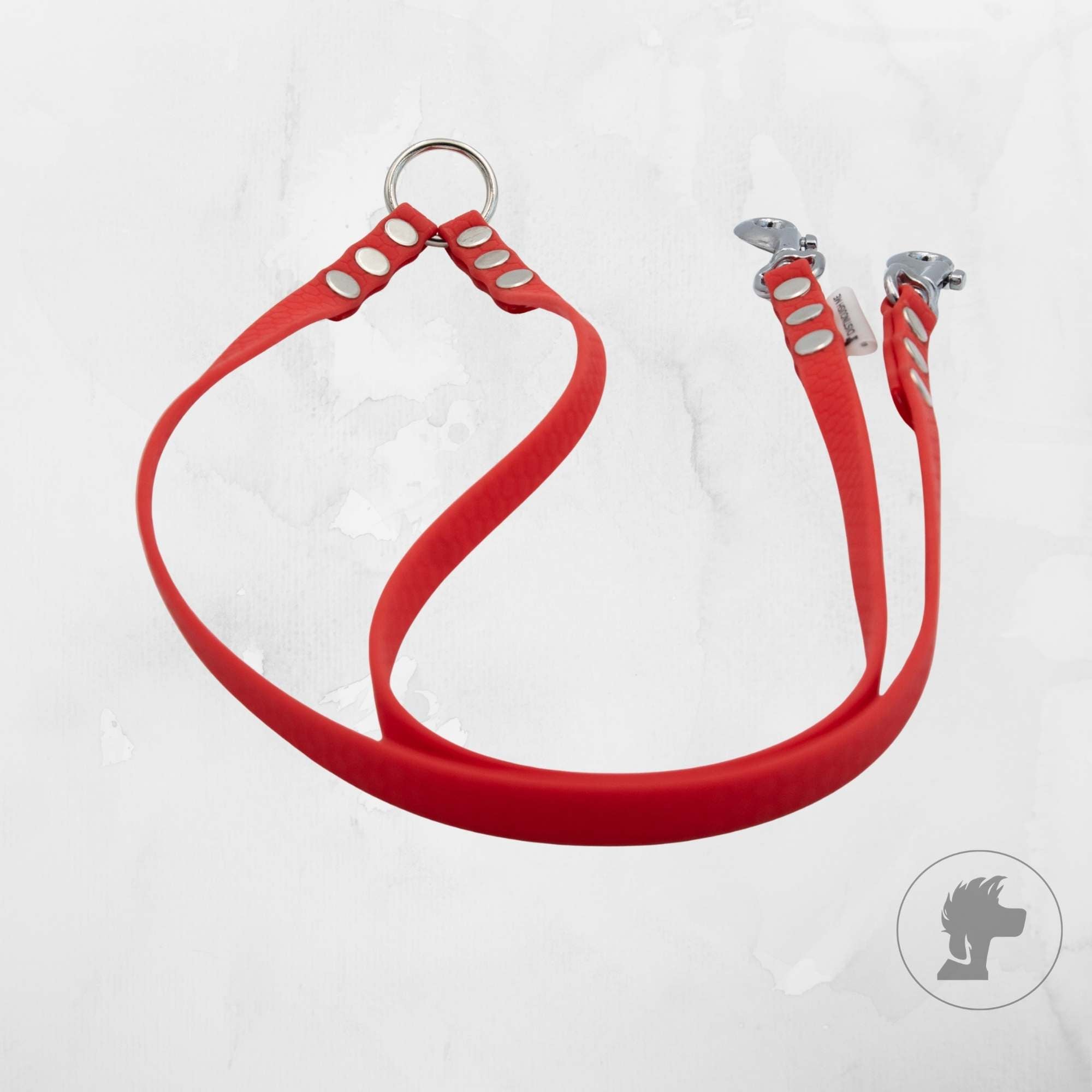Red dog collar with metal rings on a white background