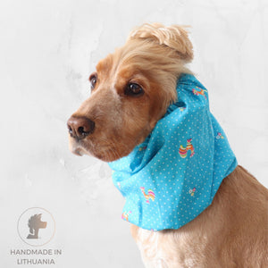 Golden English Cocker Spaniel wearing a blue cotton dog snood with small vintage rooster, flower and white dot print.
