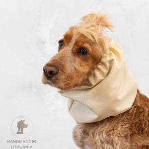 Dog wearing a beige neck wrap on a light gray background with 'Handmade in Lithuania' label.