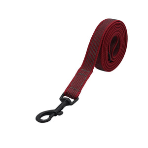 A red woven webbing dog leash with a black metal swivel snap hook, coiled on a solid white background.