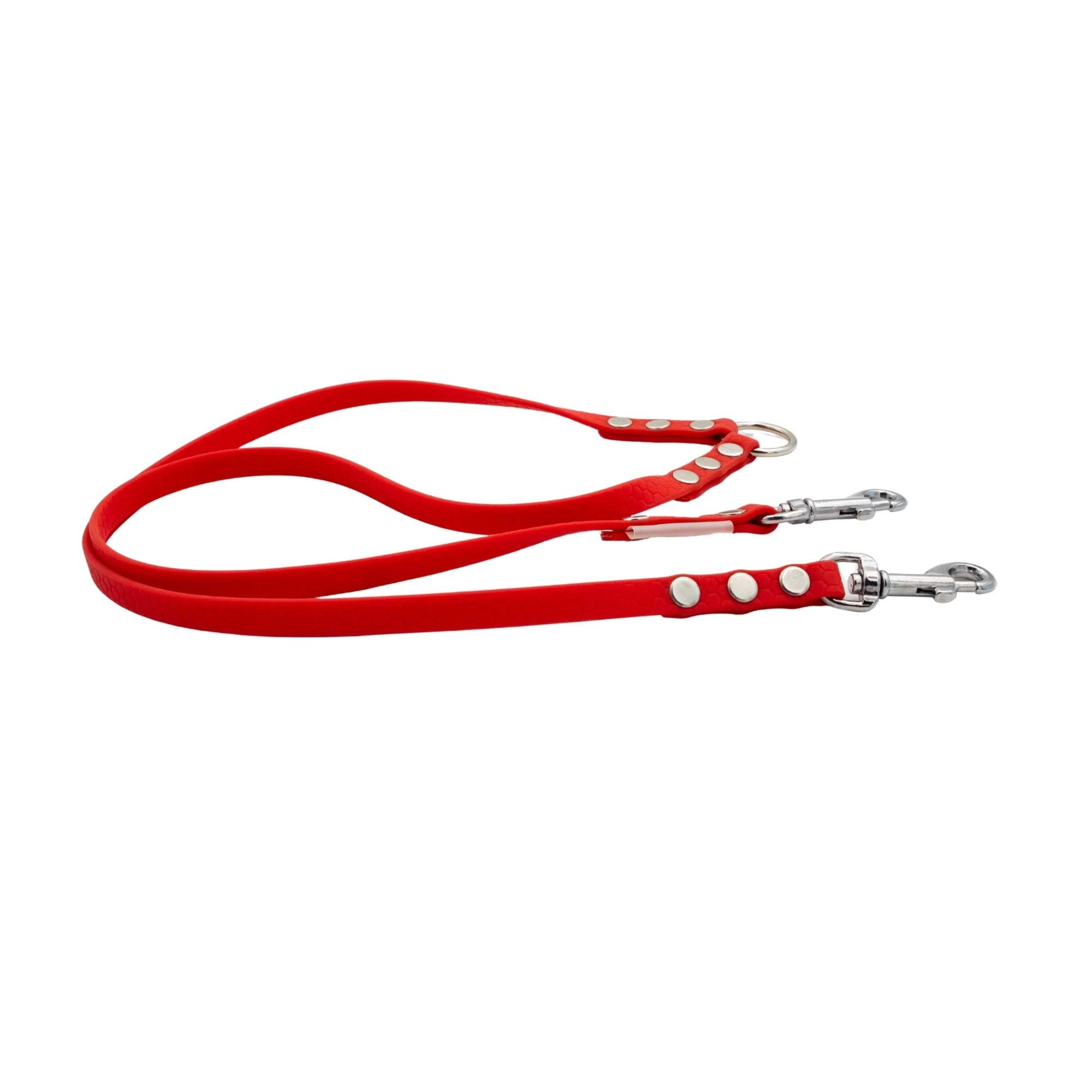 Red dog leash with silver clips on a white background