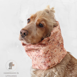 Cocker spaniel wearing a Blush Meadow waterproof dog snood in soft peach pink speckle print