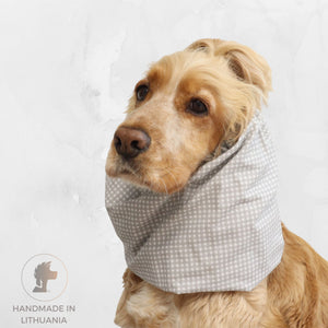 Golden Cocker Spaniel wearing the Pastel Cells lightweight cotton summer dog snood with a soft grey and white checked pattern.