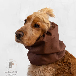 Dog wearing a brown scarf with 'Handmade in Lithuania' label on a white background