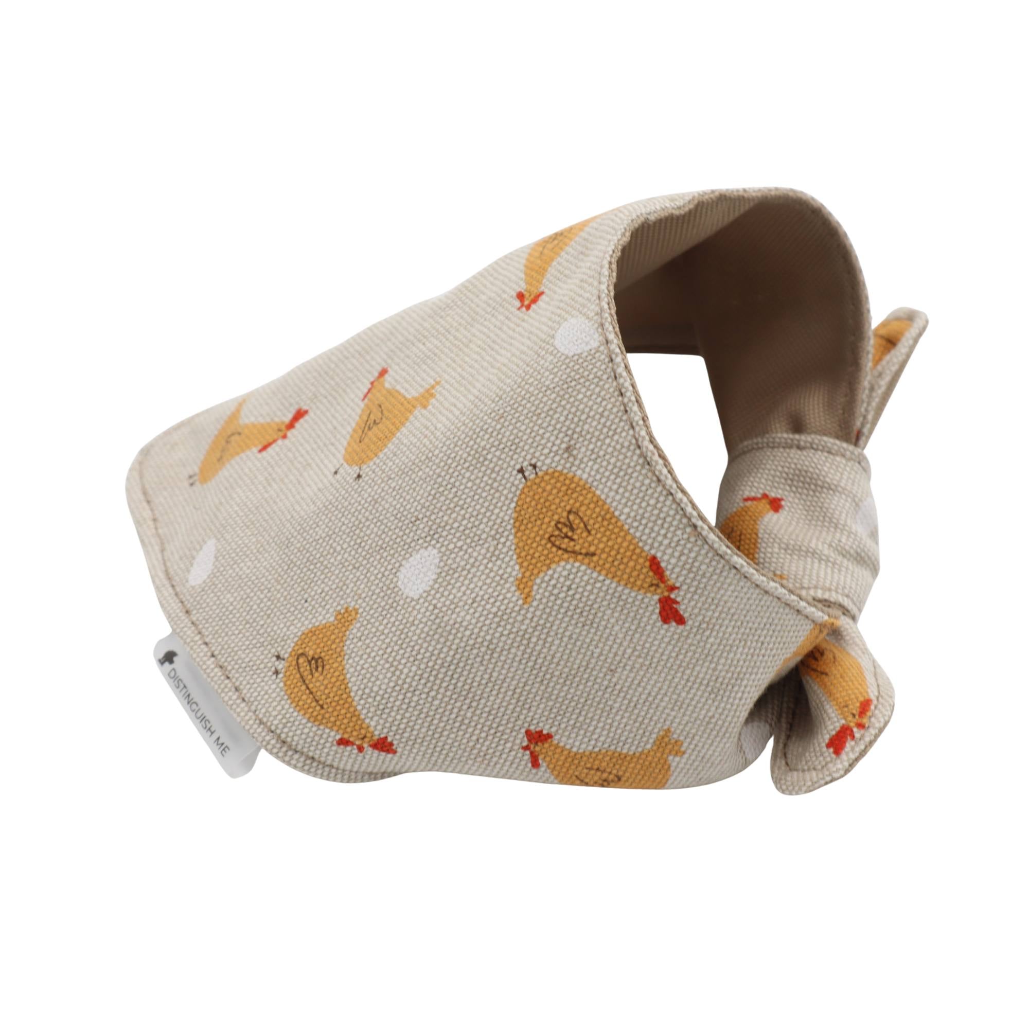 Fabric dog muzzle with chicken pattern on a beige background
