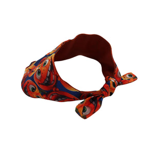 A fabric headband with a colorful cartoon monster print, featuring a dark red inner lining and tied at the front, shown on a plain white background.